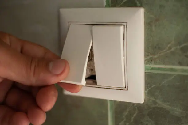 installation of an electric light switch close-up.