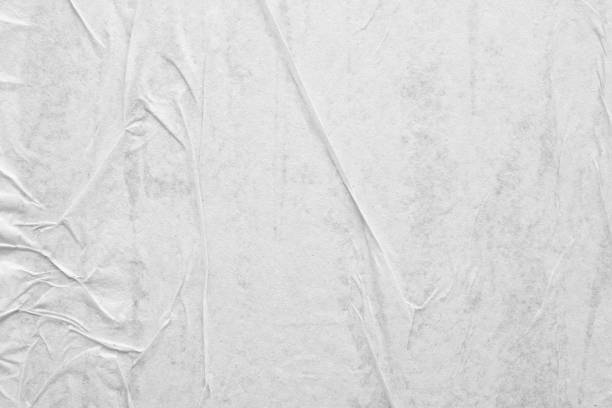 istock Blank white crumpled and creased paper poster texture background 1219461718