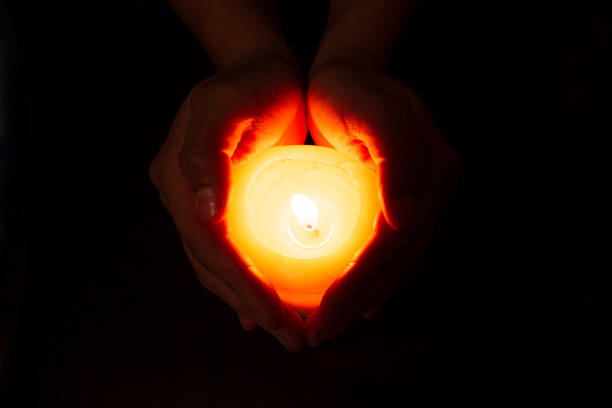 istock heart formed with hands and a burning candle 1219463204