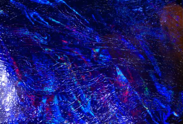 istock Room with light behind a colorful patterned glass. Glowing abstract background. 1219464528
