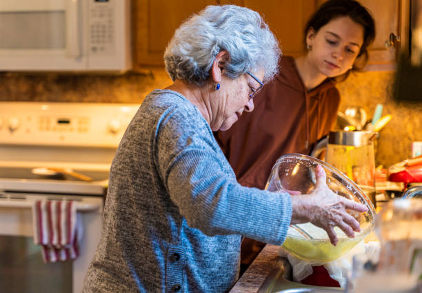 istock Grandma draining cottage cheese at the sink 1219466843