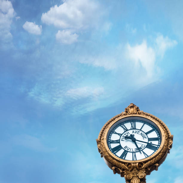 istock fifth avenue building clock with blue sky. and clouds 1219469222
