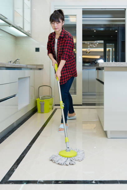 istock Woman cleaning floor in the kitchen 1219475868