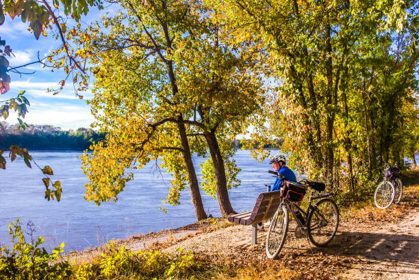 istock Older male bicyclist resting by river on nice autumn day 1219476740