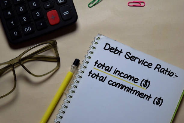 istock Debt Service Ratio write on a book isolated on Office Desk. Home loan concept 1219481900