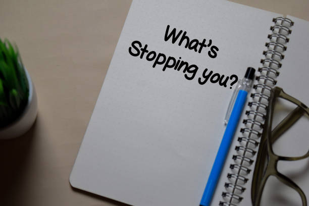 istock What's Stopping You write on a book isolated on Office Desk 1219481932