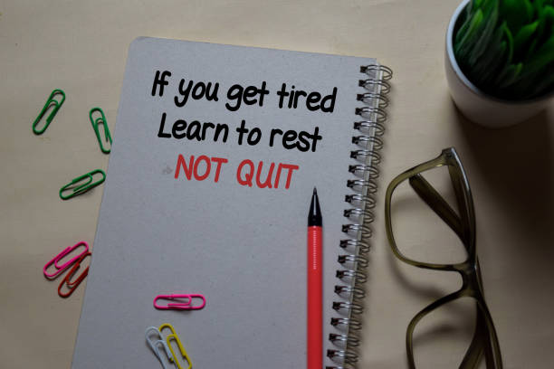 istock If you get tired. Learn to rest NOT QUIT write on a book isolated on Office Desk 1219481936