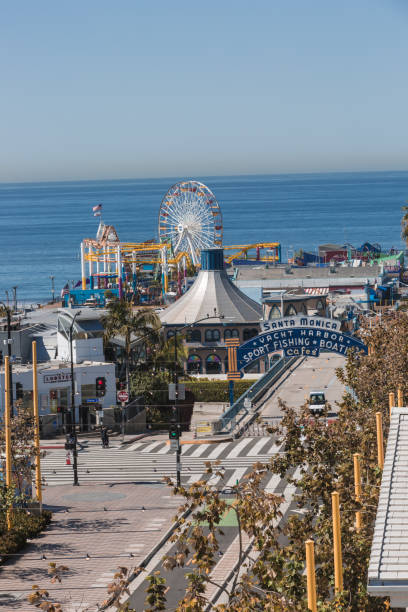 The Santa Monica Pier shown empty during the pandemic Santa Monica, CA, USA - April 15, 2020: The Santa Monica Pier closed during the covid-19 pandemic due to social distancing. The Ferris wheel of Pacific Amusement Park also shown all shutdown during the pandemic. Famous American landmark on Californian coast. abandoned roller coaster stock pictures, royalty-free photos & images