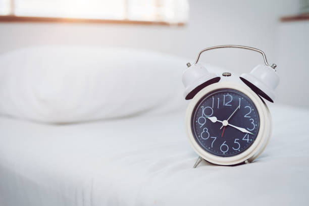 istock Bed time clock in the morning with space for text 1219494797