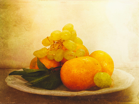 My original photo has been enhanced using the Mextures app to create an image of mandarines, leaves and grapes on an antique French plate with a dreamy, textured, romantic, rustic feel.