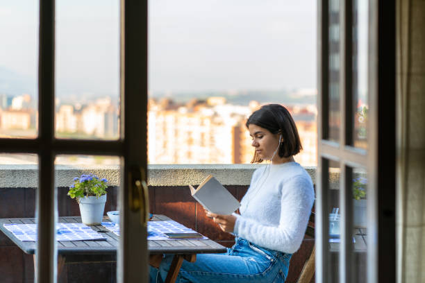 istock Woman reading a book during lockdown 1219495095