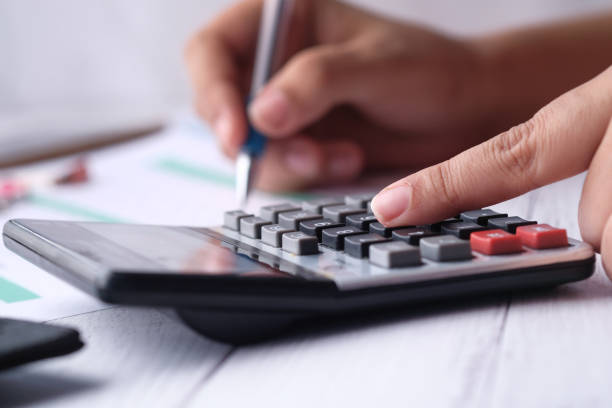 istock Woman accountant use calculator on table at office 1219495868