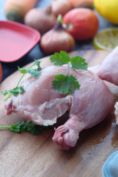 istock Raw chicken meat fillet, legs on chopping board 1219496159
