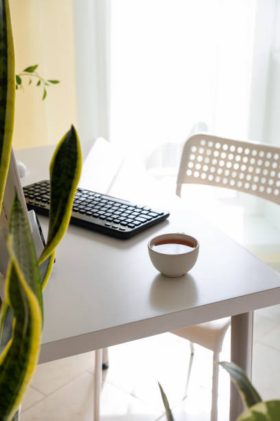 istock Home Office Desk And Chair. Desktop computer sitting on a desk in a home office. 1219497043
