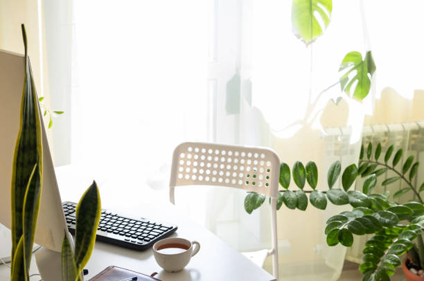 istock Home Office Desk And Chair. Desktop computer sitting on a desk in a home office. 1219497052