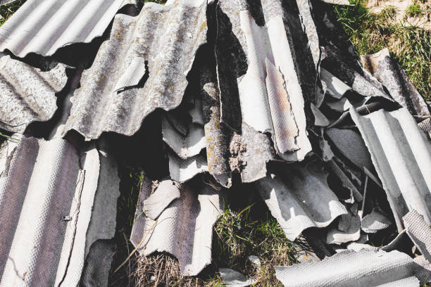 istock Asbestos roof removal . Asbestos dust in the environment. Health problems 1219497904