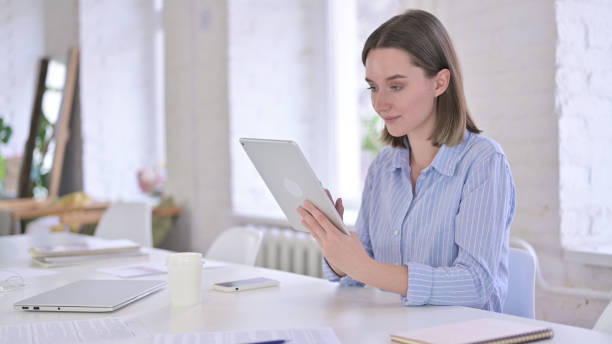 istock Happy Professional Young Woman using Tablet 1219498640