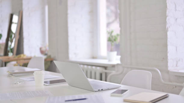 istock Beautiful Modern Office Space with Laptop On Desk 1219498651