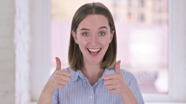 istock Thumbs Up by Young Woman Doing Video Chat 1219498875