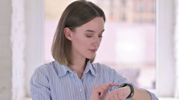 istock Portrait of Focused Young Professional using Smart Watch 1219498881