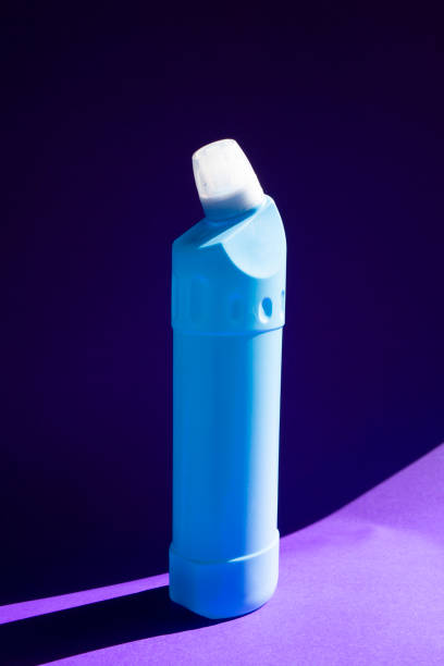 istock blue colored Detergent bottle on purple colored paper background. 1219499247