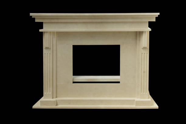 istock Natural beige marble fireplace on black background 1219503654