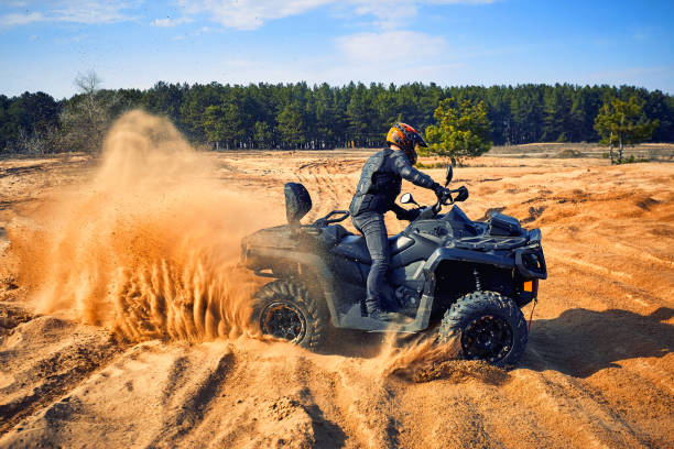 istock Racing in the sand on a four-wheel drive quad. 1219504393