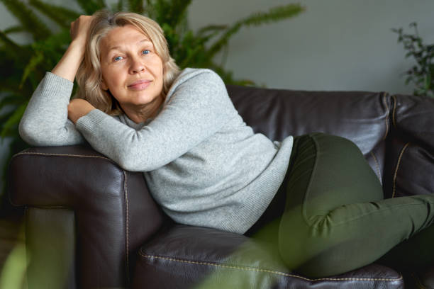 istock Happy woman is lying on the couch. 1219506727