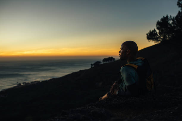 istock Sportsman resting by mountain trail at sunset 1219509044