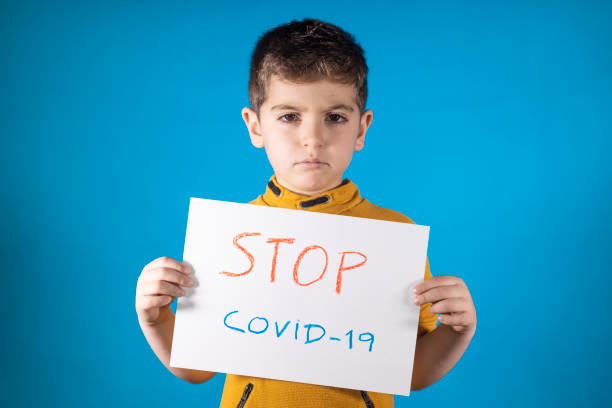 istock Little kid showing a  Stop Coronavirus drawing 1219510224