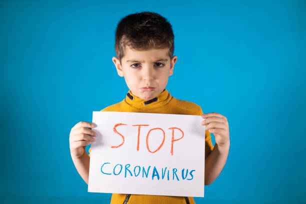 istock Little kid showing a  Stop Coronavirus drawing 1219510228