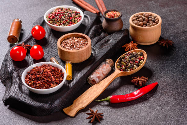 istock Pepper, salt, paprika, basil and other on a dark background 1219510249