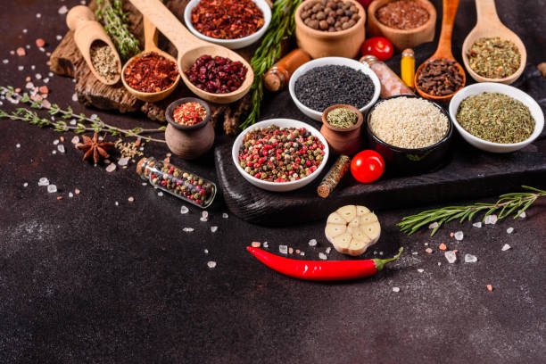 istock Pepper, salt, paprika, basil and other on a dark background 1219510301
