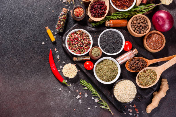 istock Pepper, salt, paprika, basil and other on a dark background 1219510308