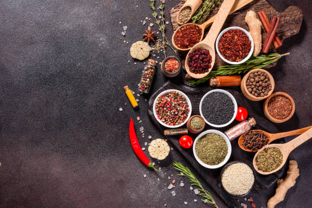 istock Pepper, salt, paprika, basil and other on a dark background 1219510313
