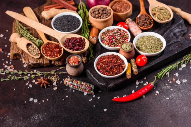 istock Pepper, salt, paprika, basil and other on a dark background 1219510328