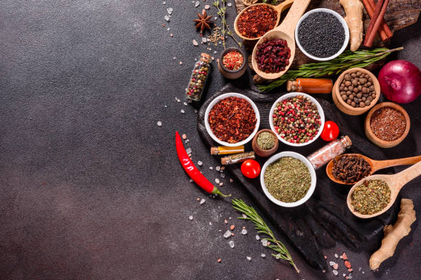 istock Pepper, salt, paprika, basil and other on a dark background 1219510336