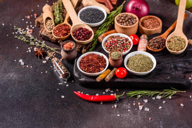 istock Pepper, salt, paprika, basil and other on a dark background 1219510369
