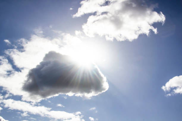 Clouds in the blue sky with a sun light. A miracle Gods light against background. Pattern from clouds in the sky.