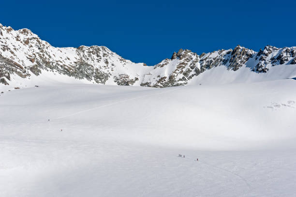 Panoramic view across snow covered valley in alpine mountain range