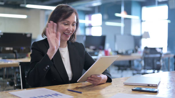 istock Serious Old Businesswoman working on Tablet in Office 1219513307