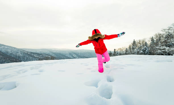 istock Woman walking through the deep snow 1219514809