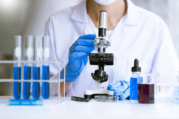 istock Medical Research asian Scientist Working With Microscope Doing Research Making Scientific Experiment, Works in a Bright Modern Laboratory 1219516176