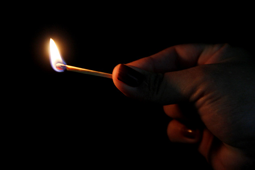salvador, bahia / brazil - february 3, 2013: matchstick lit in the dark.\