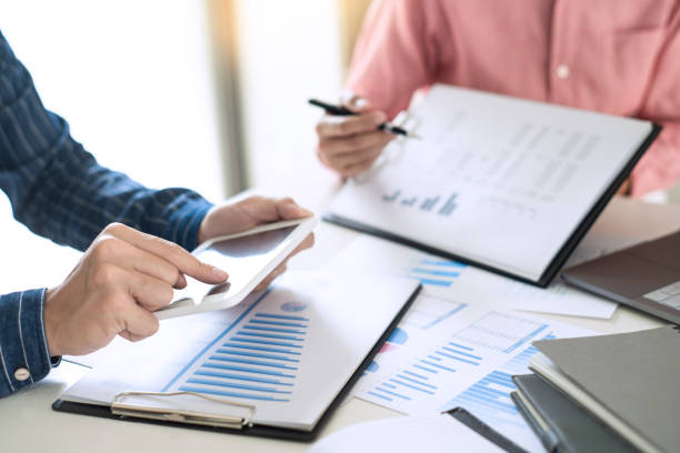 istock Business team working with plan on office desk with new startup project analyzing financial document data charts and graphs in Meeting and successful teamwork Concept 1219516743