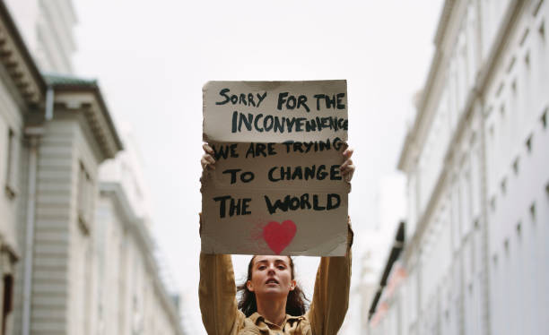 istock Woman holding poster and protesting 1219516802