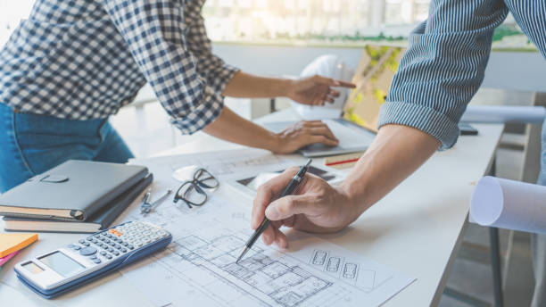 istock Cooperation Corporate designers in the office are working on a new project Planning blueprint Design at construction site at desk in office 1219516936