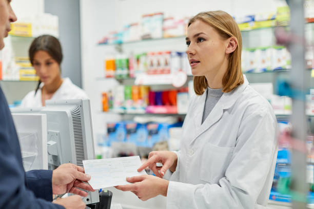 istock Pharmacy clerck explaining the indications of a medication. 1219517766
