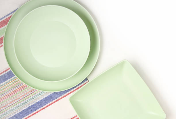 istock Clean empty plates, on a light background. Linen napkin on the table. Top view. 1219517795