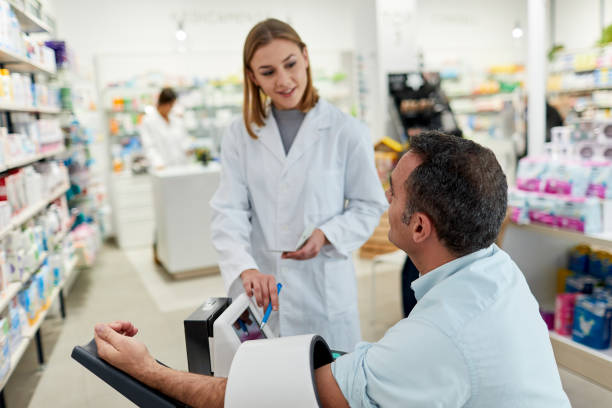 istock One young female pharmacist using a blood preasure gauge on a patient 1219518914